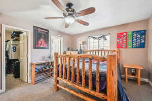 Bedroom with carpet, a textured ceiling, and ceiling fan