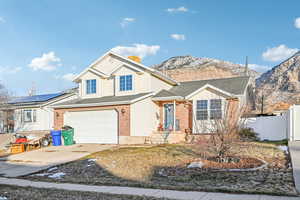 View of front of home featuring a mountain view and a garage