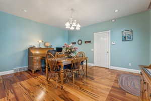 Dining room with a chandelier and light wood-type flooring