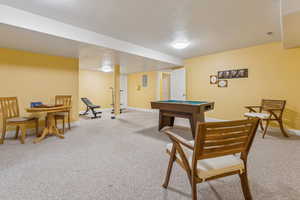 Rec room with electric panel, light carpet, and billiards