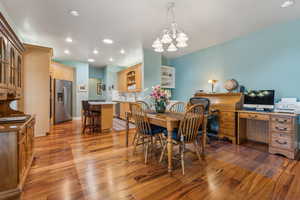 Dining area featuring hardwood / wood-style flooring, a notable chandelier, and sink