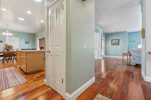 Hall with dark wood-type flooring