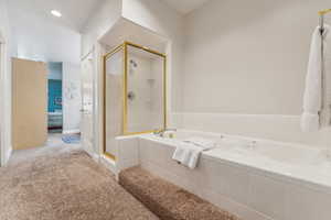 Bathroom featuring shower with separate bathtub