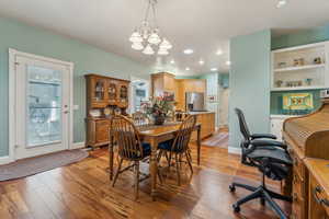 Dining room featuring a notable chandelier and light wood-type flooring