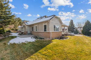 View of side of home featuring a yard