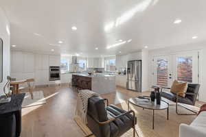 Living room featuring french doors and light wood-type flooring