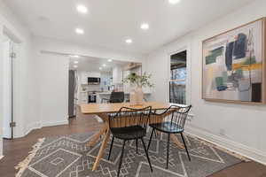 Dining space with dark hardwood / wood-style flooring