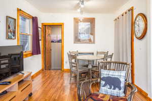 Dining room with light hardwood / wood-style flooring and ornamental molding