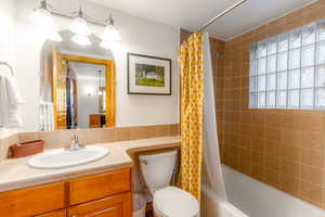 Full bathroom featuring shower / bath combo, vanity, and toilet