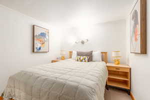 Bedroom featuring carpet flooring and crown molding