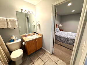 Bathroom with tile patterned floors, vanity, and toilet