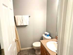 Bathroom with tile patterned flooring, vanity, and toilet