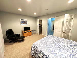 Bedroom featuring light carpet and a closet