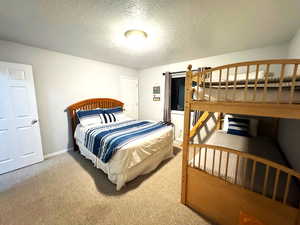 Carpeted bedroom with a textured ceiling