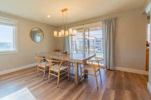 Dining area with a chandelier, hardwood / wood-style floors, and a wealth of natural light