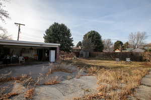 View of yard with a storage unit