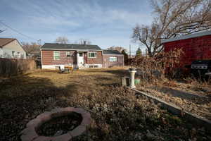 View of front of property featuring a front yard and an outdoor fire pit