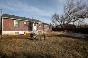 Back of property featuring a yard