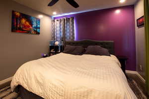 Bedroom with hardwood / wood-style floors and ceiling fan