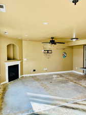 Interior space featuring concrete flooring and ceiling fan