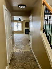 Hallway featuring a textured ceiling