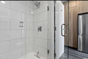 Bathroom featuring hardwood / wood-style flooring and an enclosed shower