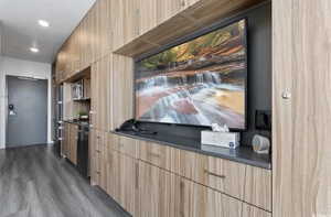 Kitchen featuring black dishwasher and dark wood-type flooring