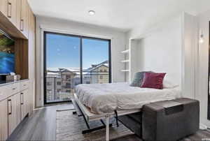 Bedroom with dark hardwood / wood-style floors