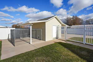 View of outbuilding with a yard