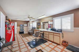 Office space featuring a textured ceiling, plenty of natural light, and ceiling fan