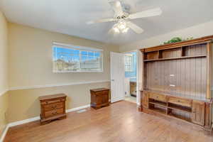 Unfurnished office with ceiling fan and light wood-type flooring