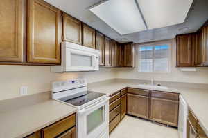 Kitchen with white appliances and sink