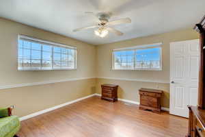 Living area featuring ceiling fan, a healthy amount of sunlight, and light hardwood / wood-style floors