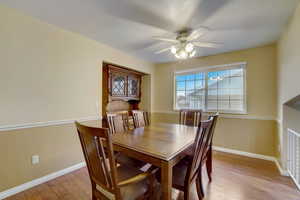 Dining area featuring ceiling fan and light hardwood / wood-style flooring