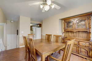 Dining space with ceiling fan and light hardwood / wood-style floors