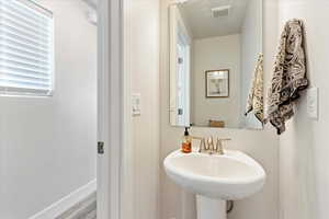 Bathroom with hardwood / wood-style floors and sink