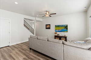 Living room with hardwood / wood-style floors and ceiling fan