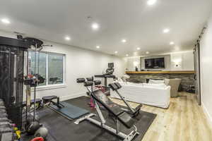 Workout area featuring light hardwood / wood-style floors