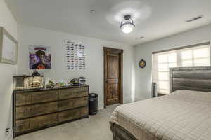 Bedroom with light colored carpet