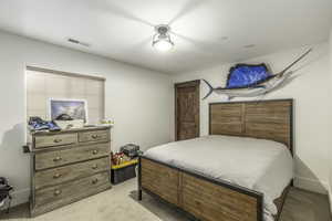 Bedroom featuring light colored carpet