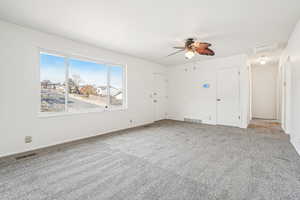 Interior space with ceiling fan and carpet floors