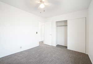 Unfurnished bedroom with carpet, ceiling fan, and a closet