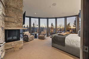 Bedroom with carpet, multiple windows, and expansive windows