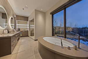 Bathroom with tile patterned flooring, vanity, and an enclosed shower