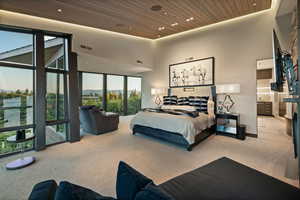 Carpeted bedroom with a towering ceiling, wood ceiling, ensuite bathroom, recessed lighting, and a mountain view