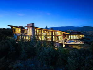 Rear view of property with a chimney, a pool, and a mountain view