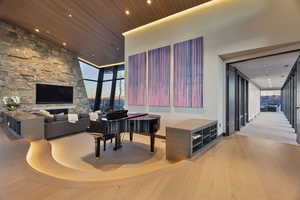 Living room featuring expansive windows, wood-type flooring, and wooden ceiling