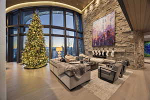 Living room featuring hardwood / wood-style floors, high vaulted ceiling, floor to ceiling windows, and wood ceiling