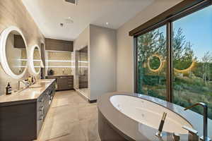 Full bathroom with double vanity, a whirlpool tub, recessed lighting, a shower stall, and backsplash
