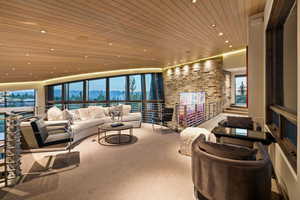 Living room featuring carpet, wooden ceiling, recessed lighting, and a mountain view
